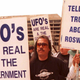 A group of protestors march in front of the General Accounting Office (GAO) 29 March to raise awareness about an examination being conducted by the GAO for documents about a weather balloon crash at Roswell, N.M. in 1947.